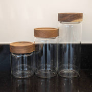 Different sized glass jars with wooden lids